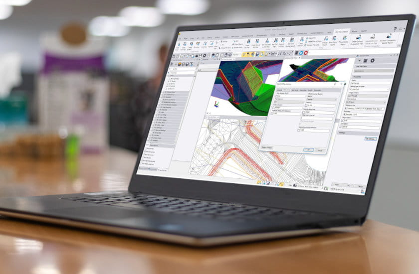 Trimble Business Center running on a laptop in an office